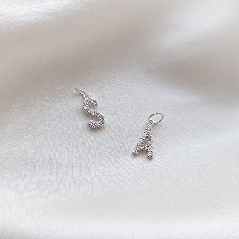 "Alias" silver letter with white stones (charm)