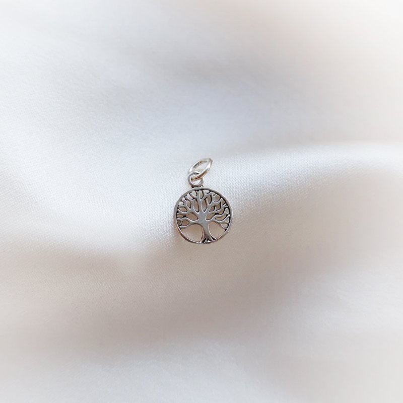 Silver charm with Tree of Life amulet