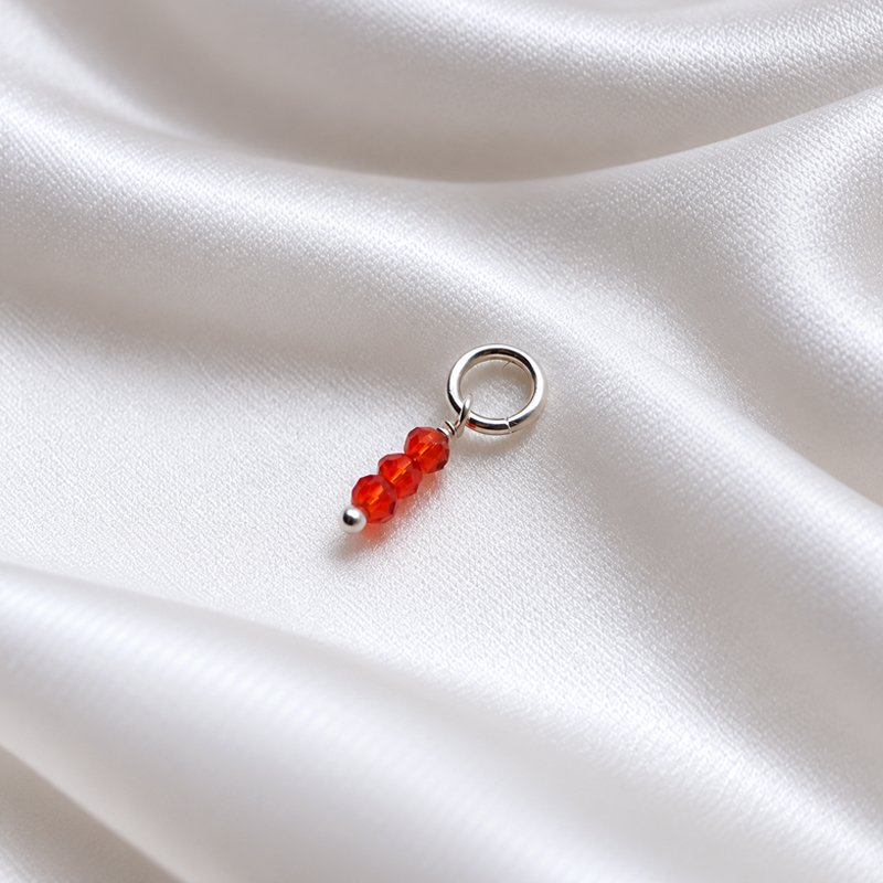 Silver charm with 3 small red glass beads