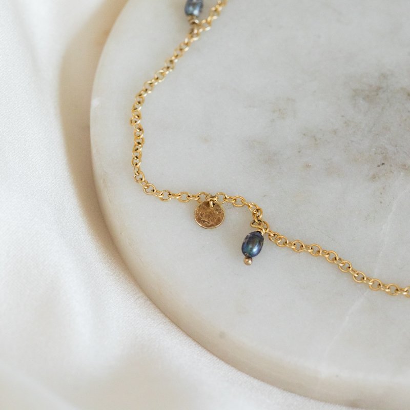 "Pittioni" gold ankle chain with blue freshwater pearls and small amulets