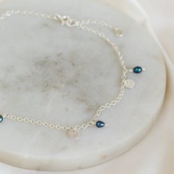 "Pittioni" silver ankle chain with freshwater pearls and small silver amulets