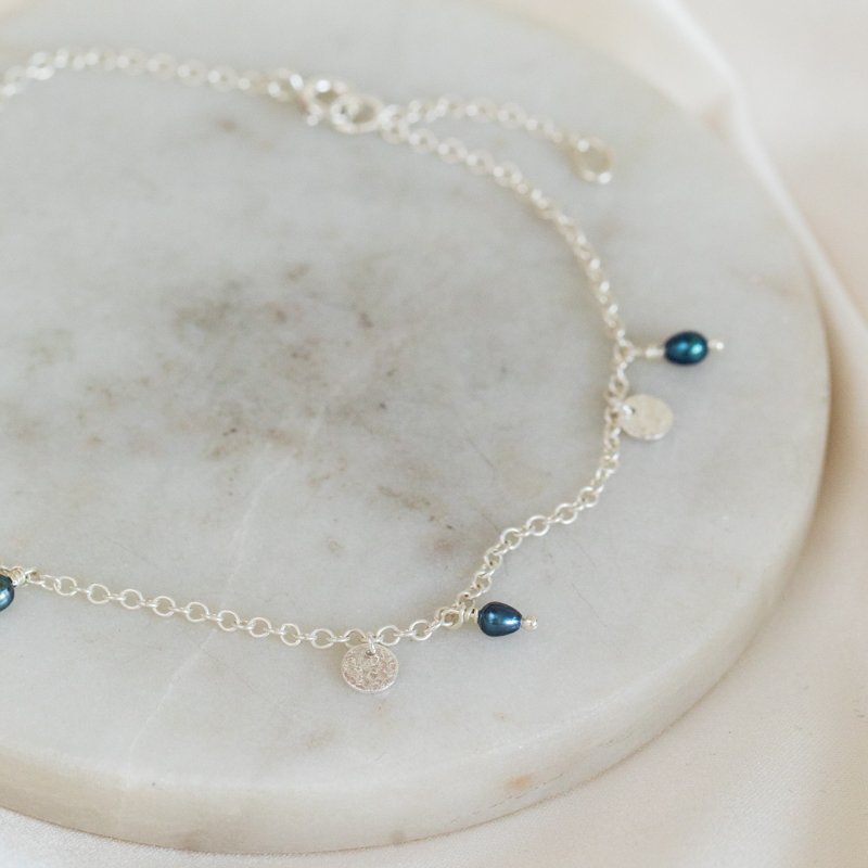 "Pittioni" silver ankle chain with freshwater pearls and small silver amulets