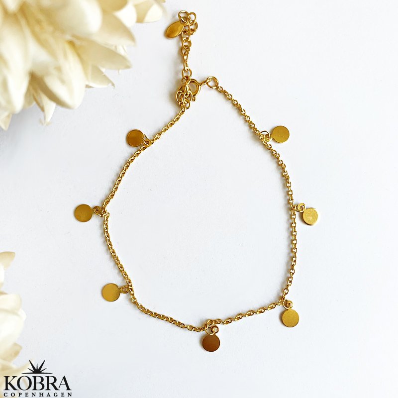 "Tennis" 18 karat forgyldt ankelkde med sm guld amuletter