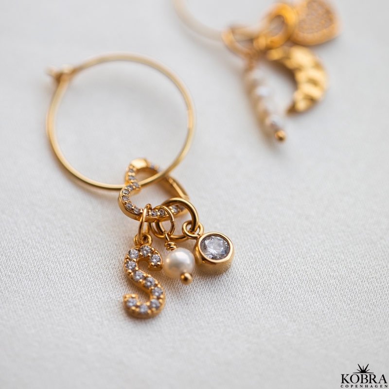 "Alias" gold letter with white stones (charm)