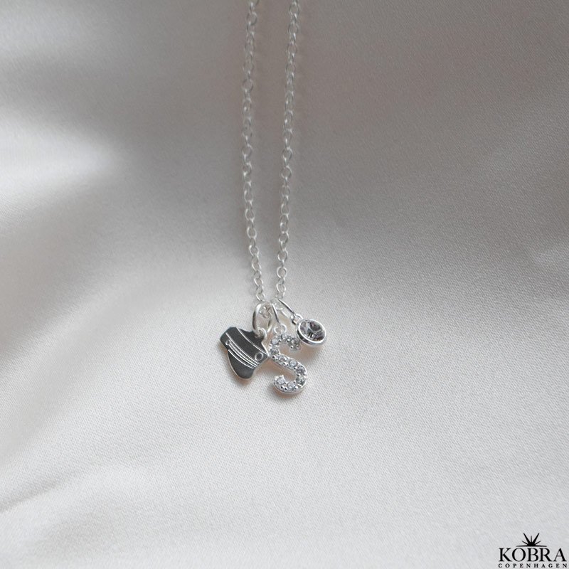 "Alias" silver letter with white stones (charm)