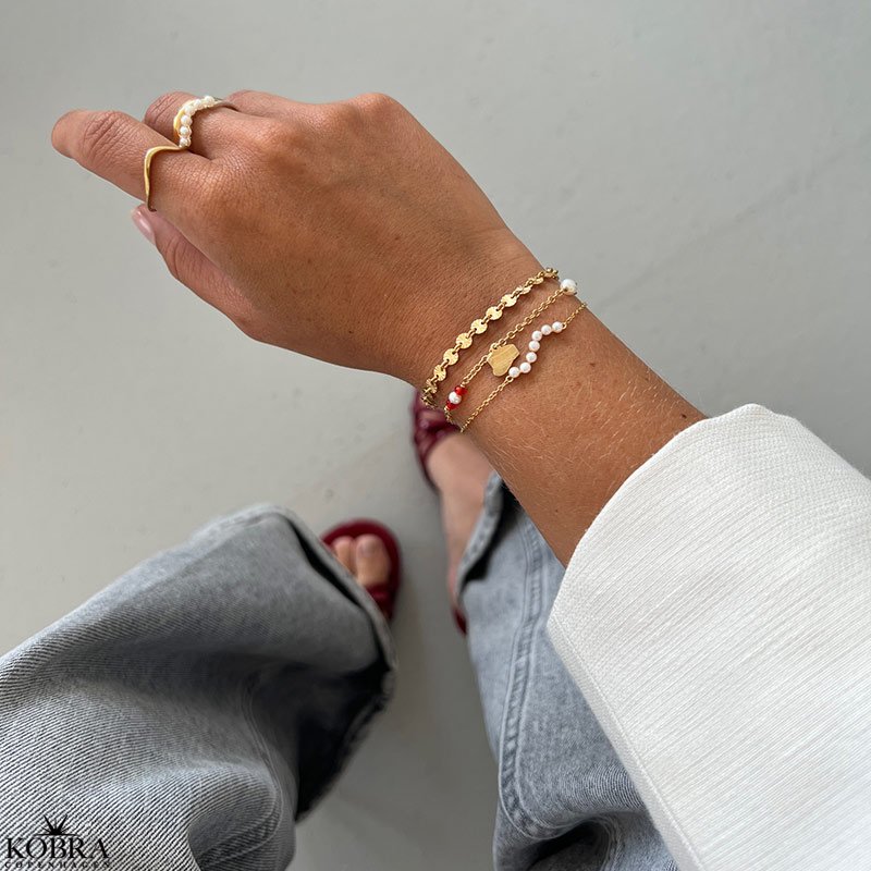 Studenter armbnd i guld med hue-vedhng og rde perler