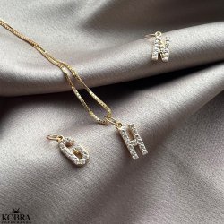 "Alias" gold letter with white stones (charm)