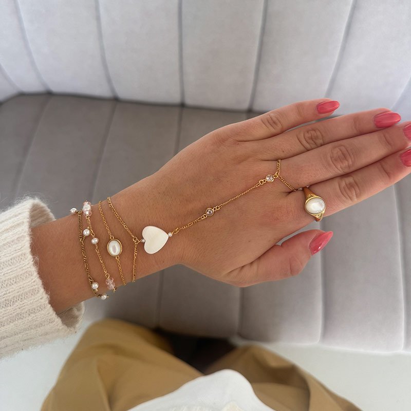 "Wild Heart" gold plated hand chain with mother of pearl
