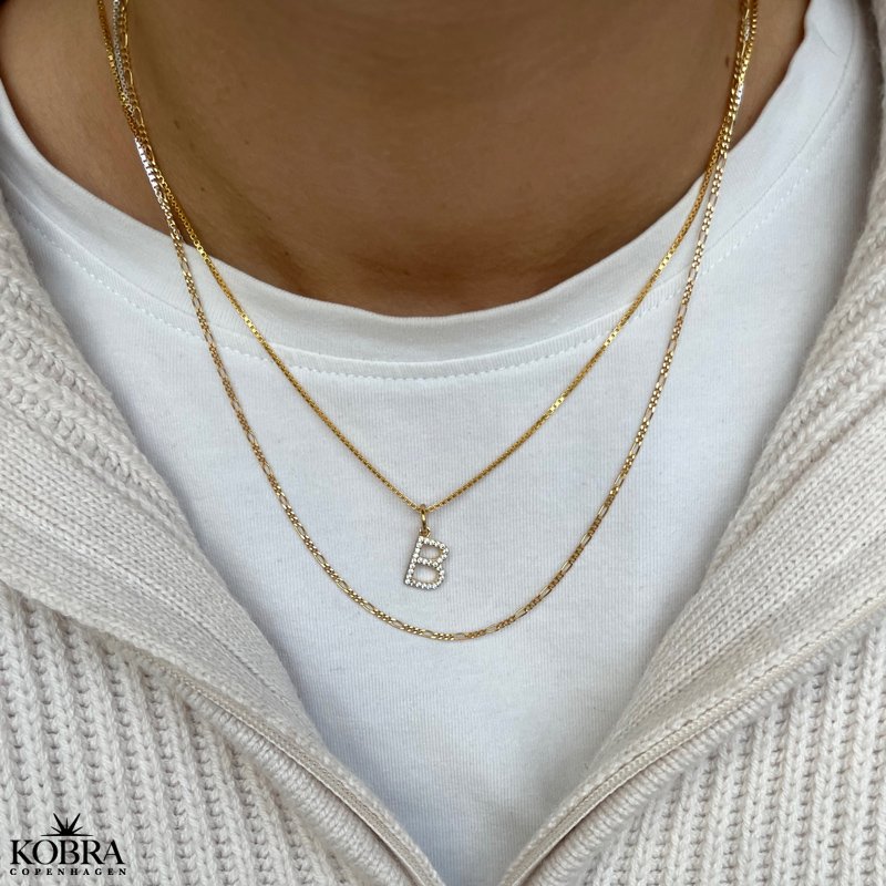 "Zoey" bogstav halskęde i guld med hvide sten