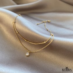 "Kaja" guld ankelkde med guldkugler og hvid sten