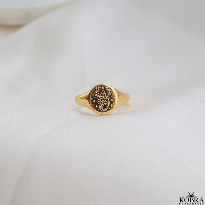 "Blazing Star" gold signet ring with your zodiac sign