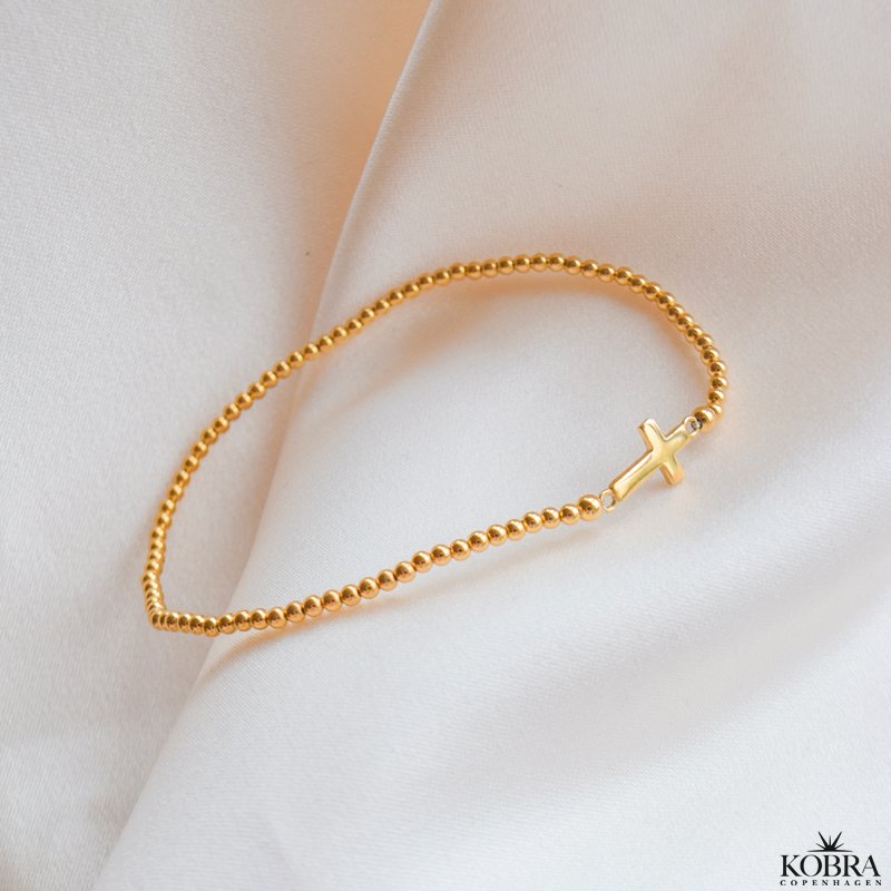 "Enna" guld kors armbnd med kugler