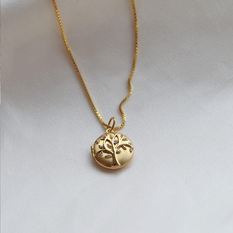 "Lia" goldplated locket with the tree of life and white stones