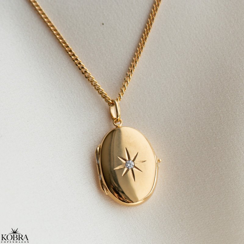"Rocket" oval guld medaljon med smuk hvid sten