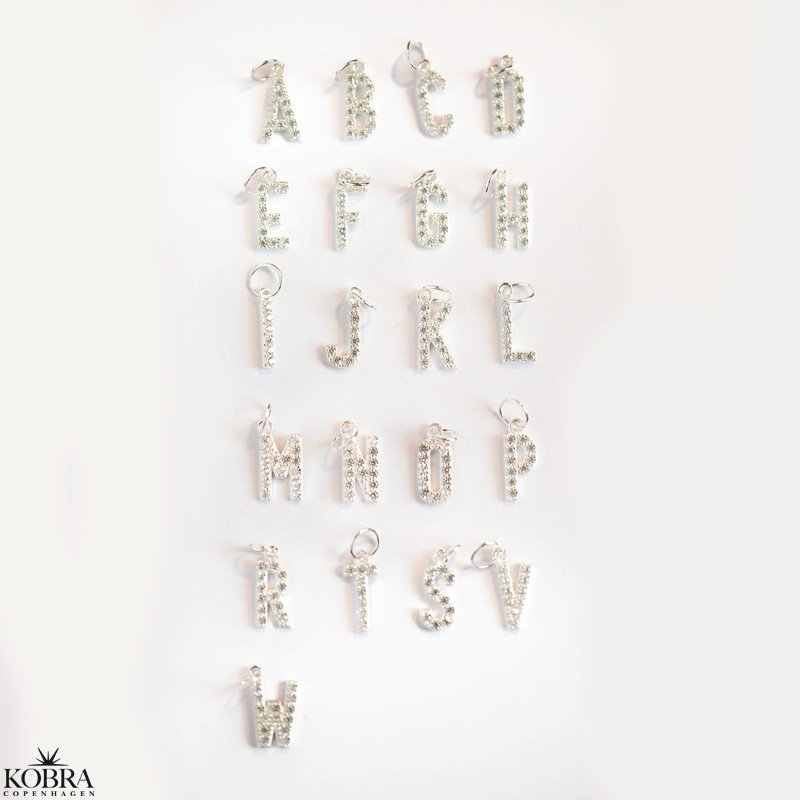 "Alias" silver letter with white stones (charm)