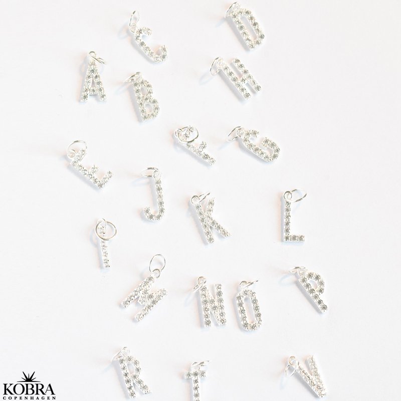 "Alias" silver letter with white stones (charm)