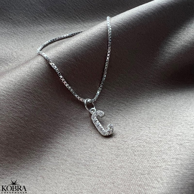 "Alias" silver letter with white stones (charm)